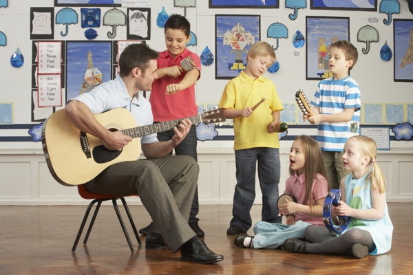 和儿童一起弹吉他的男老师图片